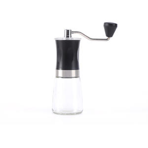 Molinillo de café manual portátil con recipiente de vidrio para uso doméstico, color negro y marrón sólido - Product Image 1