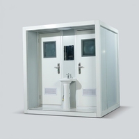 Cabine de toilette double portable avec structure en acier blanc et lavabo central pour les campings