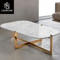 Meubles de salon de luxe sur mesure, cadre en métal doré en forme de croix, plateau rond en marbre noir, table basse