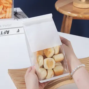 फैक्टरी थोक उच्च गुणवत्ता पुन: सील खाद्य स्टैंडिंग बैग कस्टम कॉटन पेपर ठोस रंग बेक्ड स्नैक्स विंडो ब्रेड बैग के साथ