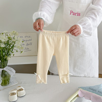 Pantalon bébé fille en coton uni à taille élastique avec nœud et dentelle pour le printemps et l'automne