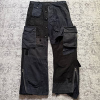 Pantalon cargo multi-poches en patchwork noir pour homme, poches à rabat utilitaires, ourlet zippé, coupe décontractée, pantalon cargo robuste de style streetwear