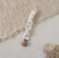 Attache-sucette artisanale en coton mousseline style bohème, motif floral vintage, avec chaîne en bois de hêtre à volants pour bébé