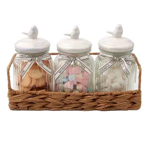 New design Custom home decor glass food storage jar with creativity bird ceramic lid candy canister in natural wicker basket