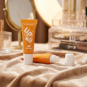 Glossy Orange PE Squeeze Tube With Small Roller Ball Applicator & <b>White</b> <b>Flat</b> <b>Cap</b> For Orange Lip Oil - Product Image 1