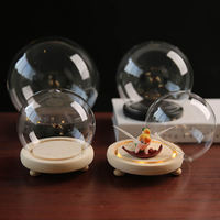 Cloche en verre transparente en forme de boule avec base en bois