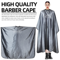 Cape de barbier imperméable finition satinée gris anthracite avec dos ouvert et col élastique pour salon de coiffure