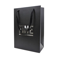 Sac en papier de luxe imprimé avec logo personnalisé en feuille d'argent pour l'emballage des vêtements