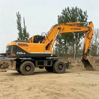 Excavatrice sur pneus Hyundai 210 d'occasion, modèle 2024, très populaire et très demandée, avec moteur Cummins, pompe hydraulique Kawasaki, moteur, engrenage et contrôle PLC