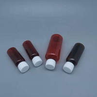 Bouteille de liquide PET ambré vide de 60ml 60cc 2oz avec sérigraphie pour emballage pharmaceutique avec tasse à mesurer