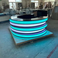 Comptoir de service LED en pierre translucide noire, moderne, rond, pour les zones de cinéma, les bars, les bureaux de réception