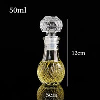 Bouteille en verre réutilisable personnalisée de 50ml & 100ml avec couvercle sculptures impression de logo pour thé vodka whisky boissons énergisantes tequila boîtes emballées