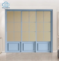 Porte coulissante intérieure française bleu clair à trois panneaux, avec panneau inférieur en verre cannelé à grille et panneau supérieur plein, pour manoir de vacances, café ou cloison.