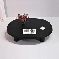 Table basse moderne en bois noir à profil bas, table à thé ovale avec pieds cylindriques, meubles de salon