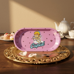 Bandeja Ovalada Metálica Rosa de 7x3 Pulgadas con Diseño de Cupido, Ángel y Demonio, Accesorios para Fumar - Product Image 1
