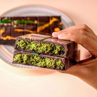 Snacks Saveur Chocolat-Pistache Style Dubaï en Gros, Pièces et Barres de Chocolats et Biscuits aux Noix à Motif de Fèves Très Demandés