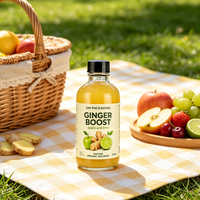 Verre Boston rond transparent de 60 ml (2 oz) avec bouchon à vis pour les boissons santé et bien-être, comme les shots de gingembre, miel, citron, curcuma, vitamines ou potions.