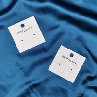 Boîte à bijoux élégante en carton ivoire avec logo imprimé en feuille d'or personnalisée pour la présentation et l'emballage de boucles d'oreilles, bagues et colliers