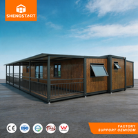 Maison conteneur extensible de luxe avec terrasse, cuisine moderne, salon, structure en acier préfabriquée, assemblage rapide, idéale pour hôtel ou petite maison.