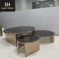 Table basse de luxe minimaliste en verre transparent ronde et moderne pieds en acier inoxydable