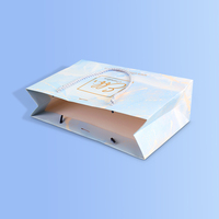 Sac de shopping en papier cartonné blanc de luxe réutilisable avec logo personnalisé, poignée en ruban et lamination
