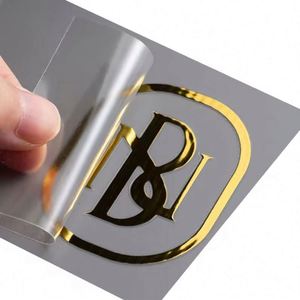 Etiquetas de Lujo 3D Transparentes con Impresión UV Personalizada a Prueba de Agua, Adhesivos con Logotipo Negro Metálico en Lámina Dorada Personalizada - Product Image 1