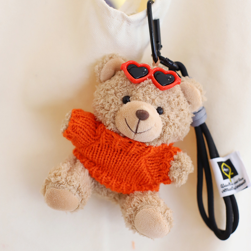 Orange sweater light brown bear hand rope
