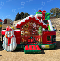 Château gonflable commercial de Noël avec toboggan, thème Père Noël, pour location événementielle