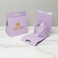 Boîte cadeau pliable portable noire de style tente avec poignée découpée, doublure en éponge et fermeture magnétique pour cosmétiques haut de gamme