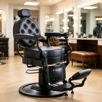 Chaise de coiffure noire gothique, cuir capitonné rond, accoudoirs en métal mat et base circulaire sur pied.