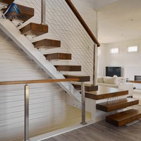 Escalier moderne en tube carré avec structure métallique à poutre unique et marches flottantes en bois