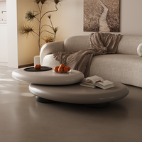 Table basse moderne en fibre de verre en forme de galet avec design rotatif pour la décoration de petits appartements