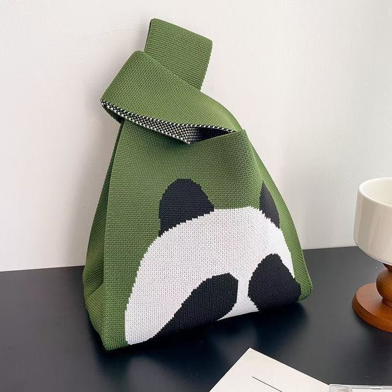 Panda covering its face in green