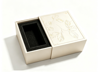 Boîte cadeau rigide à tiroir coulissant de luxe, surface à motif de feuilles en relief, insert en mousse EVA noire personnalisé pour l'emballage de parfums et de cosmétiques