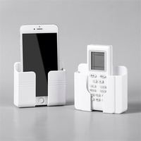 Soporte de pared adhesivo para teléfono móvil, cargador de pared y soporte para control remoto, popular y nuevo en el mercado.