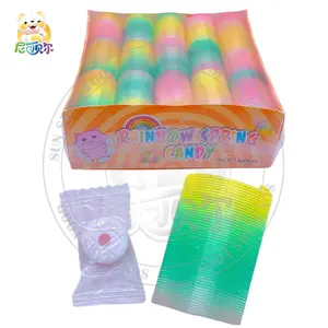 Venda quente por atacado de brinquedo de mola de PVC de desenho animado com apito unissex brinquedo arco-íris promocional de doces macios