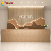 Comptoir de réception moderne crème avec comptoir arrondi, éclairage LED halo chaud, mur arqué, design minimaliste et affichage haut de gamme pour hall d'accueil