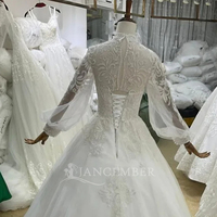 Gaun Pengantin Model Ball Gown BH30 Warna Ivory dengan Kerah Tinggi, Aplikasi Kristal, Renda Floral, Lengan Panjang, dan Tali di Bagian Belakang