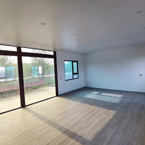 Moderna casa contenedor de dos pisos con grandes ventanas y escalera exterior para uso residencial - Product Image 2