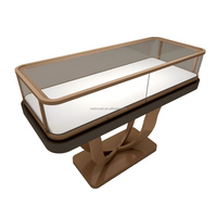 Présentoir de bijouterie en îlot, vitrine de boutique à géométrie douce, comptoir en pierre de luxe moderne, mobilier de magasin de détail OEMODM