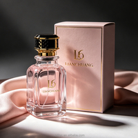 Flacon de parfum de luxe en verre givré carré avec bouchon couronne orné et pompe vaporisateur, livré dans un coffret cadeau haut de gamme