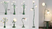 Lampe sur pied en rotin vert avec fleur blanche pour la décoration du salon