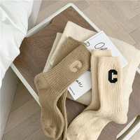 Chaussettes de sport d'hiver épaisses personnalisées Xiangyi pour femmes, haute qualité, jacquard, lettres, respirantes, tricotées, avec revers intégré
