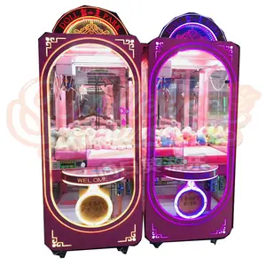 Máquina de juego de garra de parque de muñecas Rosa transparente que funciona con monedas