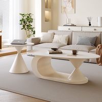 Table basse ovale de luxe moderne en pierre frittée pour petit appartement, salon, avec rangement et design durable
