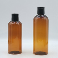 Bouteille en plastique PET ambrée en forme de balle de 16 oz, 12 oz, 8 oz avec bouchons à disque noir lisse pour l'emballage de shampoing, gel douche, lotion, huile