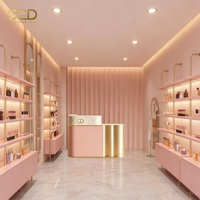 Maßgefertigte Kosmetik-Ladeneinrichtung Innendesign Rosa-Gold Ausstellungsregale Schrank mit LED-Beleuchtung für Beauty-Boutique-Geschäft