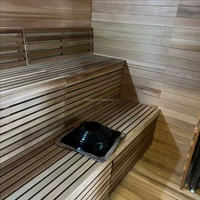 Sauna extérieur moderne en bois massif avec douche intégrée et poêle à bois