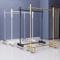 Présentoir mobile moderne en métal écologique sur pied pour magasin de vêtements féminins, idéal pour vitrine, diffusion en direct et chambre