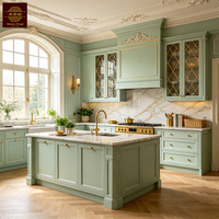 Meubles de cuisine personnalisables vert sauge, style classique français, en bois massif, avec grand îlot central et armoire de rangement en bois.